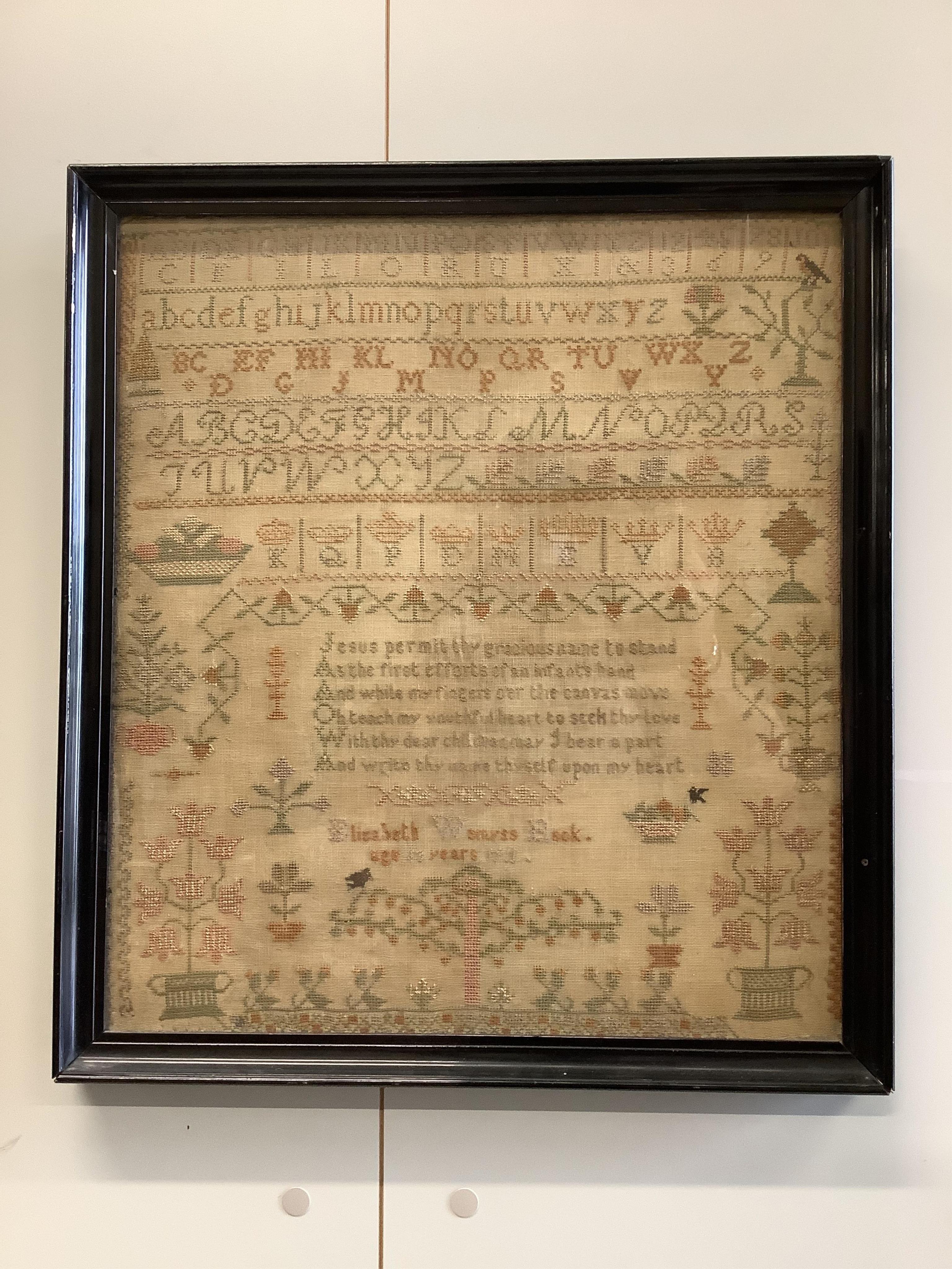 Two samplers; one late 18th century, the other early 20th century, the 18th century sampler by Elizabeth Chamberlain dated 1777, worked with an alphabet and framed verse bordered with vineous flowers, the later sampler b